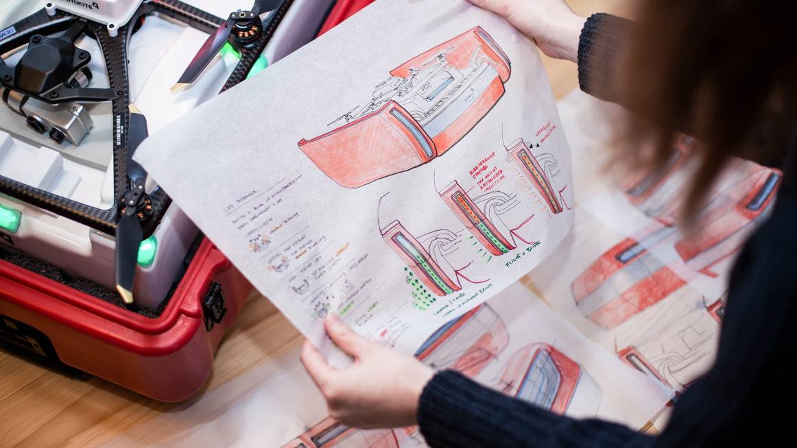 Industrial designer holding sketches of Fotokite
